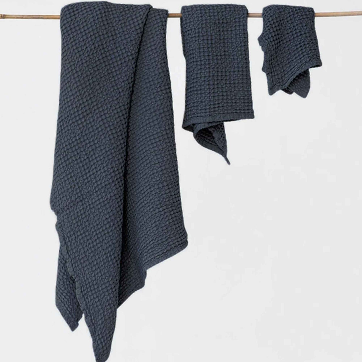 Sett med tre vaffelvevde håndklær i mørkegrå (Dark Grey) lin- og bomullsblanding (53 % lin, 47 % bomull). Inneholder ansiktshåndkle, håndhåndkle og badehåndkle i mykvasket, OEKO-TEX®-sertifisert kvalitet.