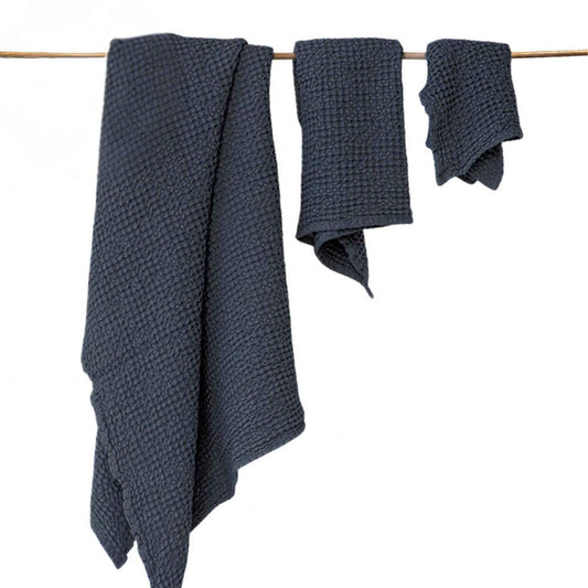 Håndkle i lin fra MagicLinen i mørkegrå, hurtigtørkende på en snor på et sunnere baderom