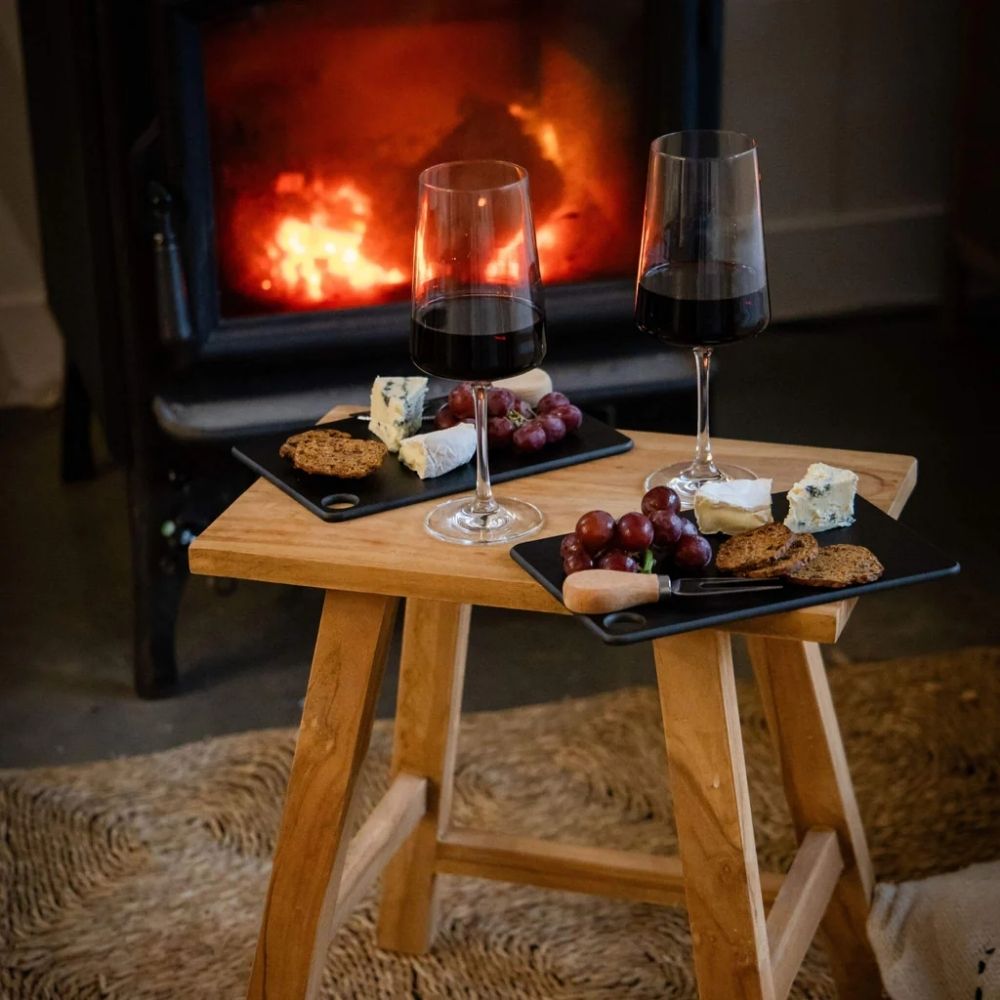 Mini Wood Fibre skjærefjøler i fargen Liquorice brukt til servering av ost og kjeks sammen med rødvin foran peisen.