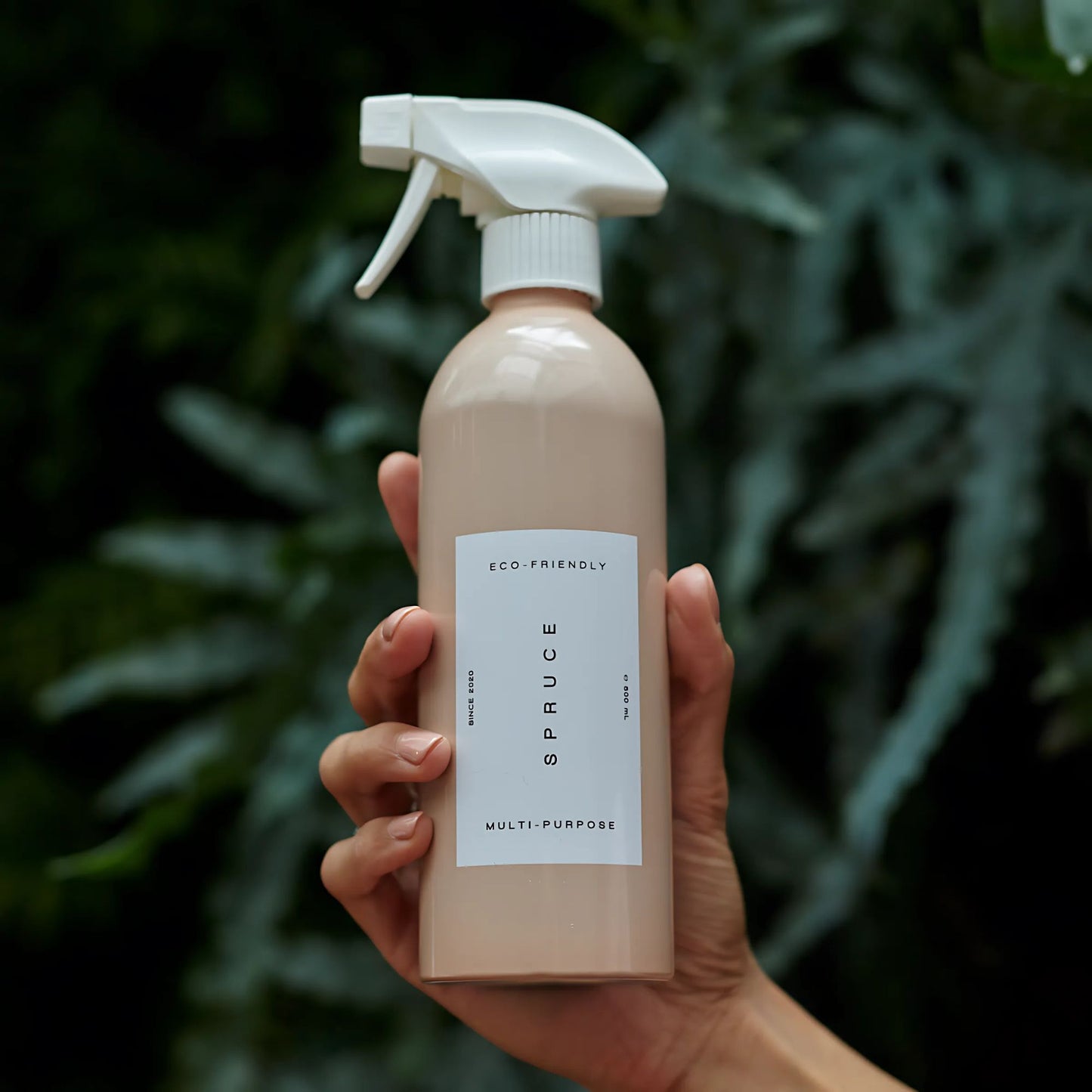 Hånd som holder Spruce Multispray evighetsflaske – trygg og giftfri rengjøring for hele hjemmet