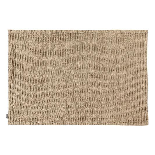  Badematte i beige med vaffelstruktur, laget av lin – et naturlig og pustende valg for et sunnere baderomsmiljø.