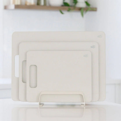 Wood fibre skjærefjøler i fargen Mushroom vist i tre størrelser på kjøkkenbenk.